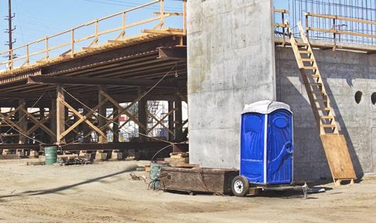 rows of portable restrooms at a work site, providing essential amenities for workers